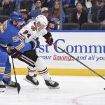 
              Chicago Blackhawks center Sam Lafferty (24) is defended by St. Louis Blues defenseman Colton Parayko (55) during the third period of an NHL hockey game Saturday, Feb. 12, 2022, in St. Louis. (AP Photo/Joe Puetz)
            