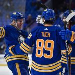 
              Buffalo Sabres defenseman Rasmus Dahlin, left, celebrates with right wings Alex Tuch (89) and Tage Thompson after scoring against the Columbus Blue Jackets during the second period of an NHL hockey game in Buffalo, N.Y., Thursday, Feb. 10, 2022. (AP Photo/Adrian Kraus)
            