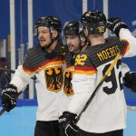 
              Germany's Tobias Rieder, center, celebrates after scoring a goal against Canada with Moritz Muller, left, and Marcel Noebels (92) during a preliminary round men's hockey game at the 2022 Winter Olympics, Thursday, Feb. 10, 2022, in Beijing. (AP Photo/Petr David Josek)
            