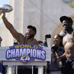
              Los Angeles Rams defensive lineman Aaron Donald, center, holds up the Vince Lombardi Super Bowl trophy as he celebrates with linebacker Ogbonnia Okoronkwo, right, during the team's victory celebration in Los Angeles, Wednesday, Feb. 16, 2022. The Rams beat the Cincinnati Bengals Sunday in the NFL Super Bowl 56 football game. (AP Photo/Marcio Jose Sanchez)
            