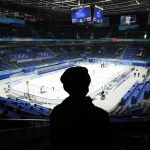 
              A man watches as the National Indoor Stadium is prepared for ice hockey at the 2022 Winter Olympics, Monday, Jan. 31, 2022, in Beijing. (AP Photo/Mark Humphrey)
            
