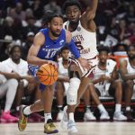 
              Kentucky guard Davion Mintz (10) dribbles the ball next to South Carolina guard Jermaine Couisnard (5) during the first half of an NCAA college basketball game Tuesday, Feb. 8, 2022, in Columbia, S.C. (AP Photo/Sean Rayford)
            
