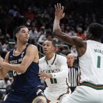 
              Notre Dame forward Paul Atkinson Jr., left, looks for an opening past Miami guard Jordan Miller (11) and forward Anthony Walker (1) during the first half of an NCAA college basketball game, Wednesday, Feb. 2, 2022, in Coral Gables, Fla. (AP Photo/Wilfredo Lee)
            