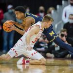 
              Michigan's Kobe Bufkin (2) gets a loose ball away from Wisconsin's Brad Davison (34) during the first half of an NCAA college basketball game Sunday, Feb. 20, 2022, in Madison, Wis. (AP Photo/Andy Manis)
            