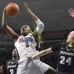 
              Connecticut's Aaliyah Edwards pulls down a rebound against Providence's Audrey Koch (24) in the first half of an NCAA college basketball game, Sunday, Feb. 27, 2022, in Storrs, Conn. (AP Photo/Jessica Hill)
            