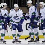 
              Vancouver Canucks left wing Juho Lammikko (91) is congratulated by teammates after scoring a goal in the second period of an NHL hockey game against the New York Rangers on Sunday, Feb. 27, 2022, in New York. (AP Photo/Adam Hunger)
            