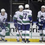 
              Vancouver Canucks defenseman Tyler Myers (57) celebrates with teammates after scoring a goal in the first period of an NHL hockey game against the New York Rangers on Sunday, Feb. 27, 2022, in New York. (AP Photo/Adam Hunger)
            