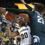 
              Michigan forward Naz Hillmon (00) shoots against Michigan State center Brooklyn Rewers (23) during the first half of an NCAA college basketball game Thursday, Feb. 24, 2022, in Ann Arbor, Mich. (AP Photo/Duane Burleson)
            