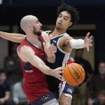 Saint Mary's guard Tommy Kuhse, left, passes the ball while being defended by Gonzaga guard Andrew Nembhard during the first half of an NCAA college basketball game in Moraga, Calif., Saturday, Feb. 26, 2022. (AP Photo/Jeff Chiu)