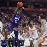 
              TCU guard Damion Baugh (10) shoots against Texas guard Marcus Carr (2) and forward Christian Bishop (32) during the first half of an NCAA college basketball game in Austin, Texas, Wednesday, Feb. 23, 2022. (AP Photo/Chuck Burton)
            