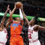 
              Oklahoma City Thunder forward Darius Bazley, center, drives to the basket against Chicago Bulls guard Coby White, left, and guard Ayo Dosunmu during the first half of an NBA basketball game in Chicago, Saturday, Feb. 12, 2022. (AP Photo/Nam Y. Huh)
            