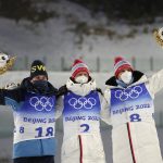 
              From left, Martin Ponsiluoma of Sweden, Johannes Thingnes Boe of Norway and Vetle Sjaastad Christiansen of Norway pose after the men's 15-kilometer mass start biathlon at the 2022 Winter Olympics, Friday, Feb. 18, 2022, in Zhangjiakou, China. (AP Photo/Kirsty Wigglesworth)
            