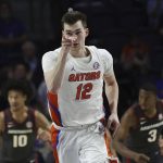 
              Florida forward Colin Castleton (12) celebrates after making a shot against Arkansas during the first half of an NCAA college basketball game Tuesday, Feb. 22, 2022, in Gainesville, Fla. (AP Photo/Matt Stamey)
            