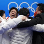 
              Sui Wenjing and Han Cong, of China, celebrate with teammates after winning the pairs free skate program during the figure skating competition at the 2022 Winter Olympics, Saturday, Feb. 19, 2022, in Beijing. (AP Photo/Natacha Pisarenko)
            