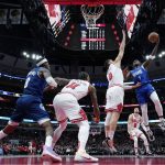 
              Minnesota Timberwolves forward Anthony Edwards, right, drives to the basket against Chicago Bulls center Nikola Vucevic, second from right, during the first half of an NBA basketball game in Chicago, Friday, Feb. 11, 2022. (AP Photo/Nam Y. Huh)
            