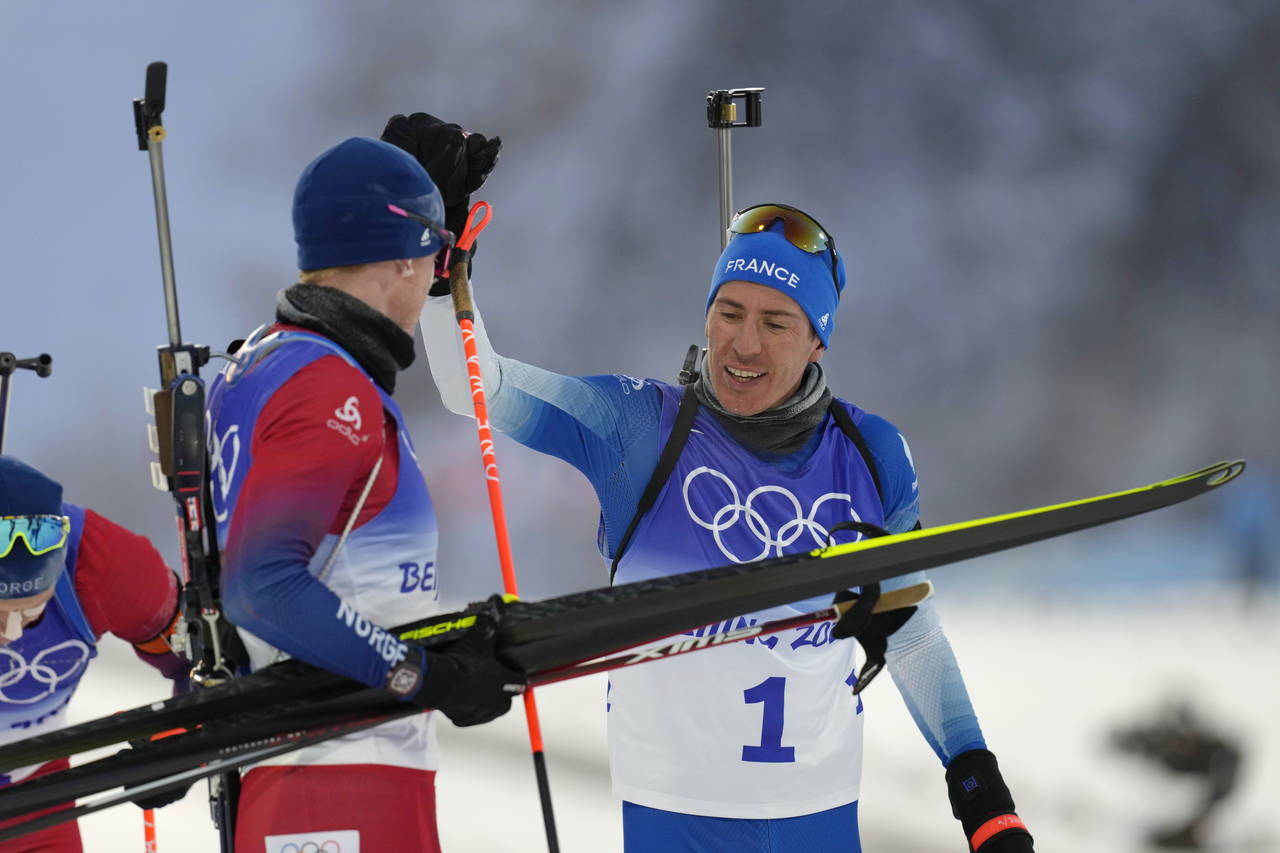 Quentin Fillon Maillet of France (1) greets Johannes Thingnes Boe of Norway after the men's 15-kilo...