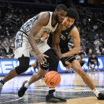 
              Georgetown center Timothy Ighoefe, left, and Providence forward Justin Minaya, right, battle for the ball during the first half of an NCAA college basketball game, Sunday, Feb. 6, 2022, in Washington. (AP Photo/Nick Wass)
            