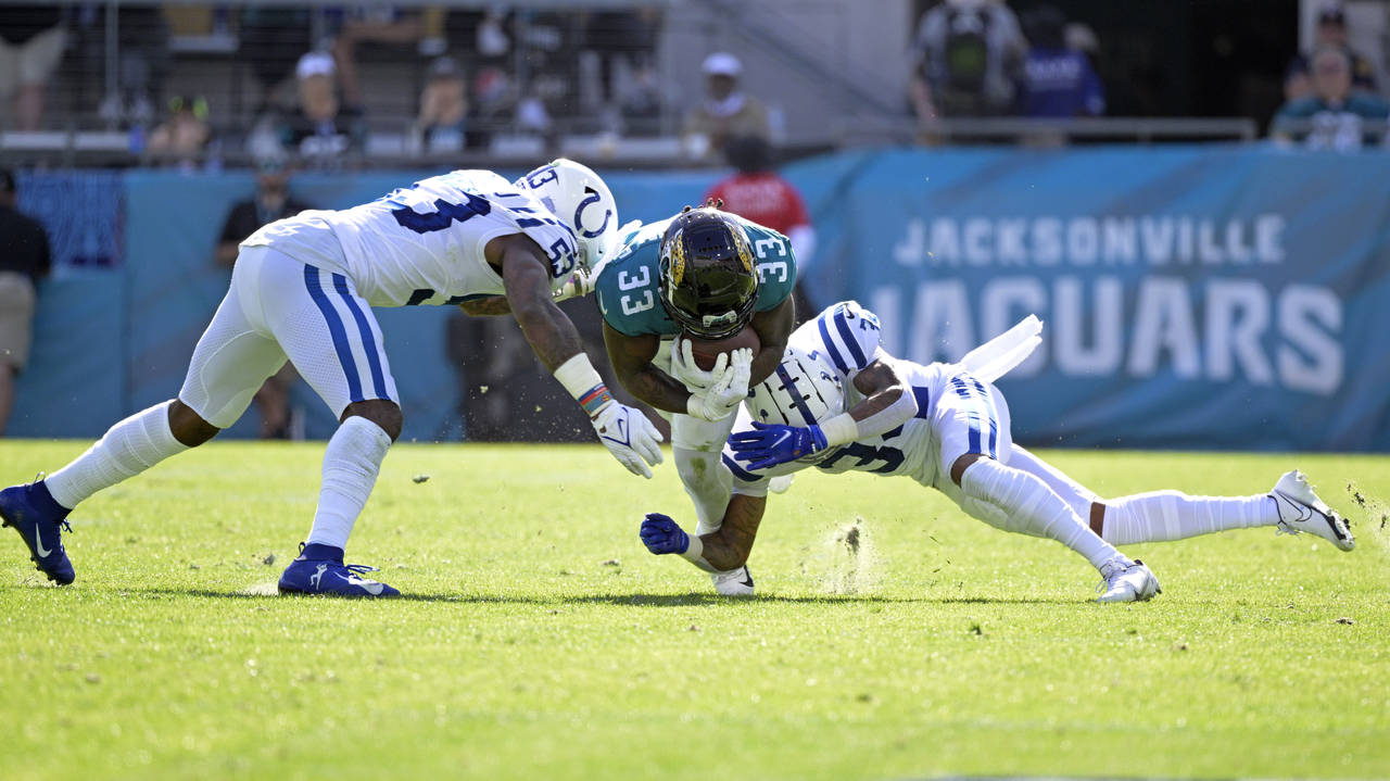 Jacksonville Jaguars running back Dare Ogunbowale (33) is stopped by Indianapolis Colts outside lin...