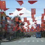 
              Chinese flags hang over a street in the majority-Tibetan town of Litang, in southwestern China's Sichuan province on Sunday, Sept. 6, 2020. Ahead of the Beijing summer Olympics 14 years ago, Tibet was on fire. Deadly clashes between Tibetans and security forces in Lhasa made global headlines, and for weeks, monks and herders battled bullets and batons.  But today, Tibet has fallen silent, even as the Olympic games come to Beijing for a second time. (AP Photo/Dake Kang)
            