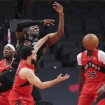 
              Miami Heat centre Bam Adebayo (13) and Toronto Raptors guard Fred VanVleet (23) watch the ball get away during the first half of an NBA basketball game Tuesday, Feb. 1, 2022, in Toronto. (Nathan Denette/The Canadian Press via AP)
            