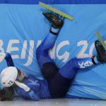 
              Olga Tikhonova of Kazakhstan, crashes in her heat of the women's 1000-meters during the short track speedskating competition at the 2022 Winter Olympics, Wednesday, Feb. 9, 2022, in Beijing. (AP Photo/Natacha Pisarenko)
            