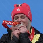 
              CORRECTS NAME TO ANNA BERRETIER INSTEAD NATALIE GEISENBERG - Anna Berretier, of Germany, kisses the silver medal at the podium of the luge women's singles at the 2022 Winter Olympics, Tuesday, Feb. 8, 2022, in the Yanqing district of Beijing. (AP Photo/Mark Schiefelbein)
            