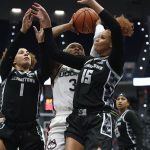 
              Connecticut's Aaliyah Edwards shoots under pressure from Georgetown's Kelsey Ransom (1) and Georgetown's Brianna Scott (15) in the first half of an NCAA college basketball game, Sunday, Feb. 20, 2022, in Hartford, Conn. (AP Photo/Jessica Hill)
            