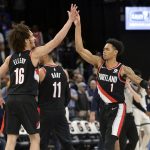 
              Portland Trail Blazers guards CJ Elleby (16) and Anfernee Simons (1) high five in the second half of an NBA basketball game against the Memphis Grizzlies Wednesday, Feb. 16, 2022, in Memphis, Tenn. (AP Photo/Brandon Dill)
            