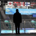 
              A man watches as the National Indoor Stadium is prepared for ice hockey at the 2022 Winter Olympics, Jan. 31, 2022, in Beijing. (AP Photo/Mark Humphrey)
            