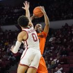 
              Oklahoma State guard Bryce Thompson, right, shoots as Oklahoma guard Jordan Goldwire (0) defends in the first half of an NCAA college basketball game Saturday, Feb. 26, 2022, in Norman, Okla. (AP Photo/Sue Ogrocki)
            