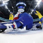 
              Sweden's Carl Klingberg (48) and Anton Lander, right, celebrate after teammate Lucas Wallmark, not shown, scored a goal past Slovakia goalkeeper Matej Tomek, center, during a preliminary round men's hockey game at the 2022 Winter Olympics, Friday, Feb. 11, 2022, in Beijing. (Song Yanhua/Pool Photo via AP)
            