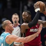 
              Miami Heat center Bam Adebayo (13) keeps the ball from Charlotte Hornets center Mason Plumlee (24) during the first half of an NBA basketball game in Charlotte, N.C., Saturday, Feb. 5, 2022. (AP Photo/Jacob Kupferman)
            