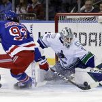 
              Vancouver Canucks goaltender Thatcher Demko stops a shot by New York Rangers center Mika Zibanejad (93) in the first period of an NHL hockey game Sunday, Feb. 27, 2022, in New York. (AP Photo/Adam Hunger)
            