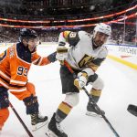 
              Vegas Golden Knights' William Carrier (28) and Edmonton Oilers' Ryan Nugent-Hopkins (93) battle for the puck during the first period of an NHL hockey game Tuesday, Feb. 8, 2022, in Edmonton, Alberta. (Jason Franson/The Canadian Press via AP)
            