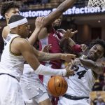 
              Arkansas' Trey Wade, center, vies for a rebound against Missouri's Kobe Brown, right, Jarron Coleman, left, and Trevon Brazile during the first half of an NCAA college basketball game Tuesday, Feb. 15, 2022, in Columbia, Mo. (AP Photo/L.G. Patterson)
            
