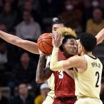 
              Alabama guard J.D. Davison (3) is defended Vanderbilt forward Quentin Millora-Brown, rear, and guard Scotty Pippen Jr. (2) during the first half of an NCAA college basketball game Tuesday, Feb. 22, 2022, in Nashville, Tenn. (AP Photo/Mark Zaleski)
            