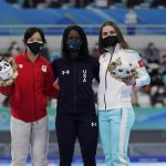 
              Gold Medalist Erin Jackson of the United States, center, poses with silver medalist Miho Takagi of Japan and bronze medalist Angelina Golikova of the Russian Olympic Committee, right, during a venue ceremony for the speedskating women's 500-meter race at the 2022 Winter Olympics, Sunday, Feb. 13, 2022, in Beijing. (AP Photo/Ashley Landis)
            
