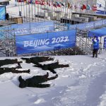 
              Workers pose as snow angels for a picture at Genting Snow Park prior at the 2022 Winter Olympics, Jan. 31, 2022, in Zhangjiakou, China. (AP Photo/Lee Jin-man)
            