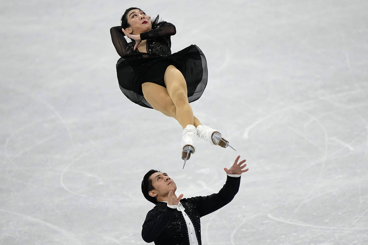 Sui Wenjing and Han Cong, of China, compete in the pairs short program during the figure skating co...
