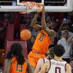 
              Oklahoma State forward Moussa Cisse (33) dunks in the second half of an NCAA college basketball game against Oklahoma, Saturday, Feb. 26, 2022, in Norman, Okla. (AP Photo/Sue Ogrocki)
            