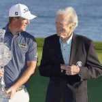 
              Tom Hoge, left, talks with Clint Eastwood on the 18th green of the Pebble Beach Golf Links after winning the AT&T Pebble Beach Pro-Am golf tournament in Pebble Beach, Calif., Sunday, Feb. 6, 2022. (AP Photo/Eric Risberg)
            