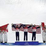 
              From left silver medal winners China's Xu Mengtao, Jia Zongyang and Qi Guangpu; gold medal winners United States' Ashley Caldwell, Christopher Lillis and Justin Schoenefeld; and bronze medal winners Canada's Marion Thenault, Miha Fontaine and Lewis Irving celebrate during the venue award ceremony for the mixed team aerials finals at the 2022 Winter Olympics, Thursday, Feb. 10, 2022, in Zhangjiakou, China. (AP Photo/Francisco Seco)
            
