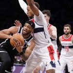 
              Brooklyn Nets forward Bruce Brown, left, attempts a pass against Washington Wizards center Daniel Gafford, center, in the second half of an NBA basketball game, Thursday, Feb. 17, 2022, in New York. (AP Photo/John Minchillo)
            