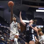 
              Connecticut's Christyn Williams shoots over Villanova's Brianna Herlihy (14) in the second half of an NCAA college basketball game, Wednesday, Feb. 9, 2022, in Hartford, Conn. (AP Photo/Jessica Hill)
            