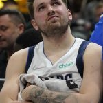 
              Dallas Mavericks guard Luka Doncic sits on the bench during the first half of the team's NBA basketball game against the Utah Jazz on Friday, Feb. 25, 2022, in Salt Lake City. (AP Photo/Rick Bowmer)
            