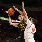 
              Iowa forward Patrick McCaffery (22) goes to the basket against Maryland forward Simon Wright (15) during the first half of an NCAA college basketball game, Thursday, Feb. 10, 2022, in College Park, Md. (AP Photo/Nick Wass)
            