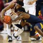 
              West Virginia guard Malik Curry tries to steal the ball from Iowa State guard Tyrese Hunter, left, during the second half of an NCAA college basketball game, Wednesday, Feb. 23, 2022, in Ames, Iowa. (AP Photo/Charlie Neibergall)
            