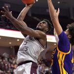 
              Texas A&M forward Henry Coleman III (15) makes a basket as LSU center Efton Reid (15) defends during the second half of an NCAA college basketball game Tuesday, Feb. 8, 2022, in College Station, Texas. (AP Photo/Sam Craft)
            