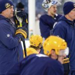 
              Nashville Predators head coach John Hynes, right, works with his team during a hockey practice in preparation for the Navy Federal Credit Union NHL Stadium Series at Nissan Stadium in Nashville, Tenn., Friday, Feb. 25, 2022. (Andrew Nelles/The Tennessean via AP)
            