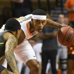 
              Oklahoma State guard Avery Anderson III, right, looks past Baylor defenders during the first half an NCAA college basketball game Monday, Feb. 21, 2022, in Stillwater, Okla. (AP Photo/Brody Schmidt)
            
